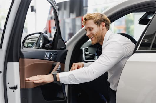 Image of a customer inspecting the interior of their SUV, purchased at RightRide