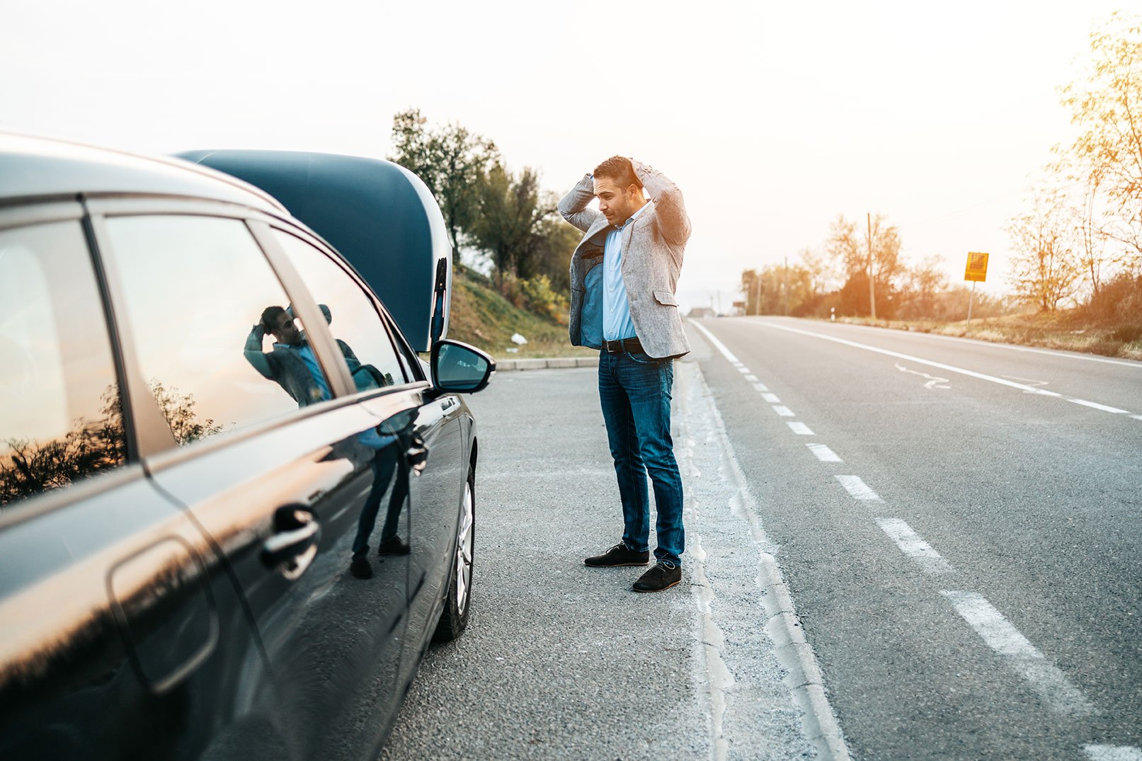 Man Holding Hands on Head after Car Broke Down